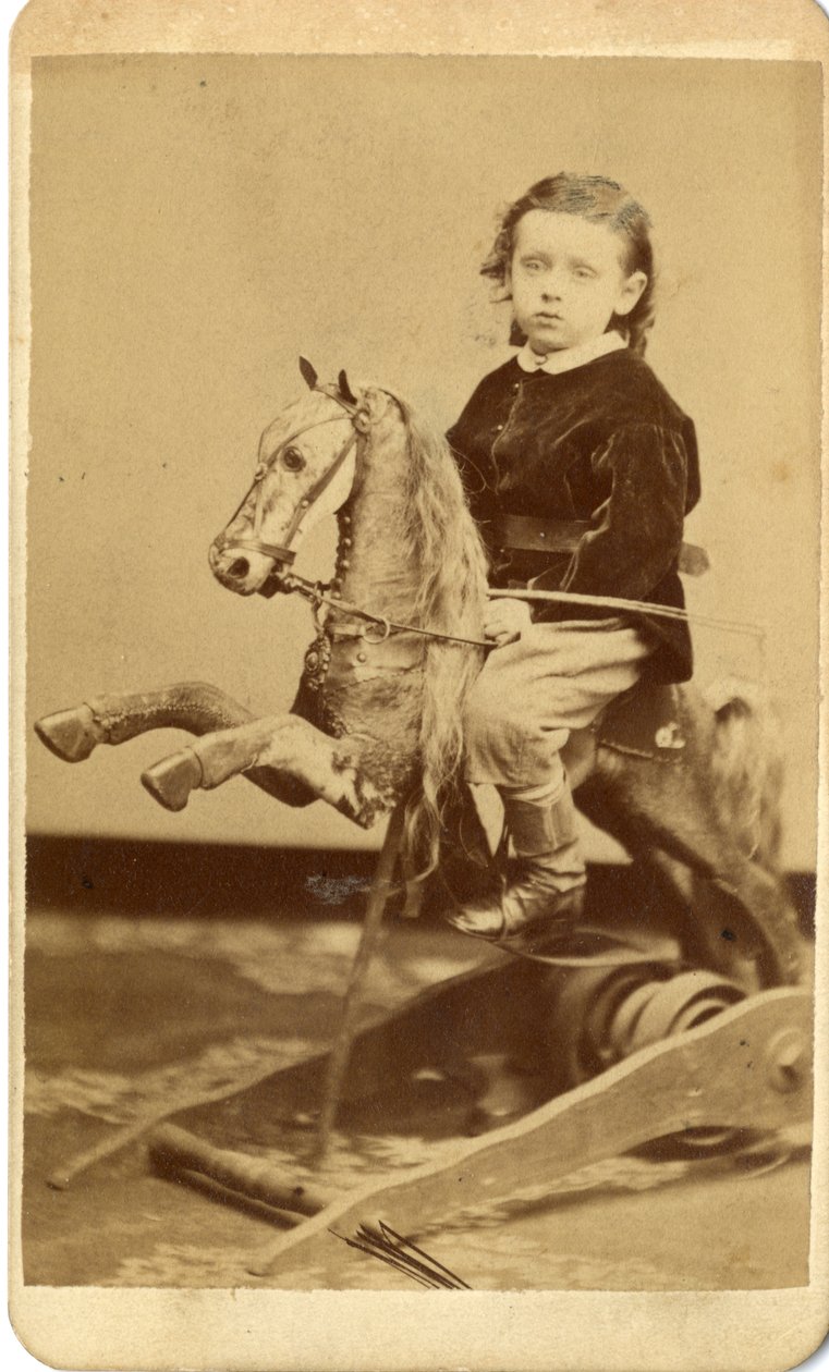 Junge mit Peitsche auf Schaukelpferd von John McCaffrey