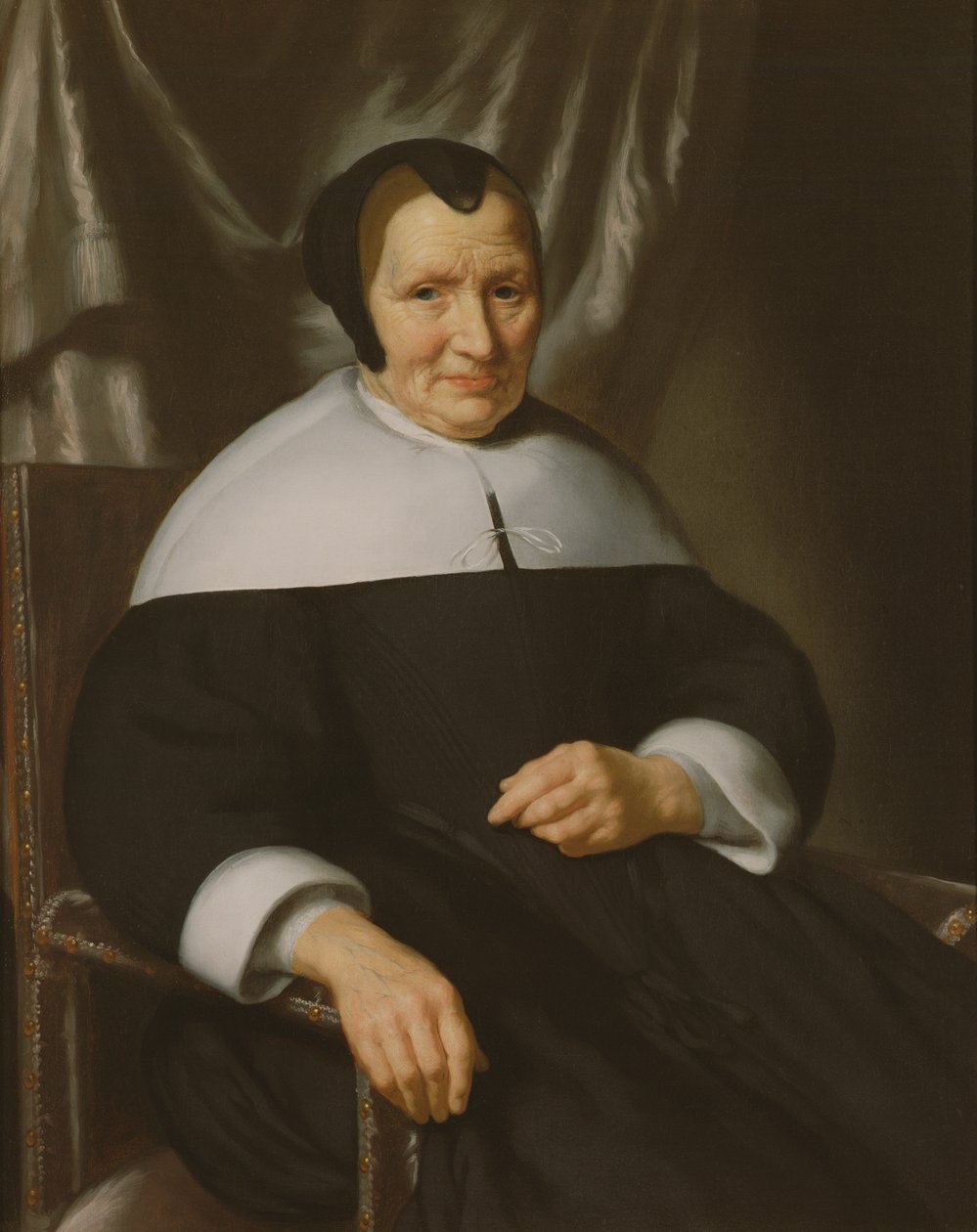 Porträt einer Dame, die in einem Sessel sitzt von Nicolaes Maes