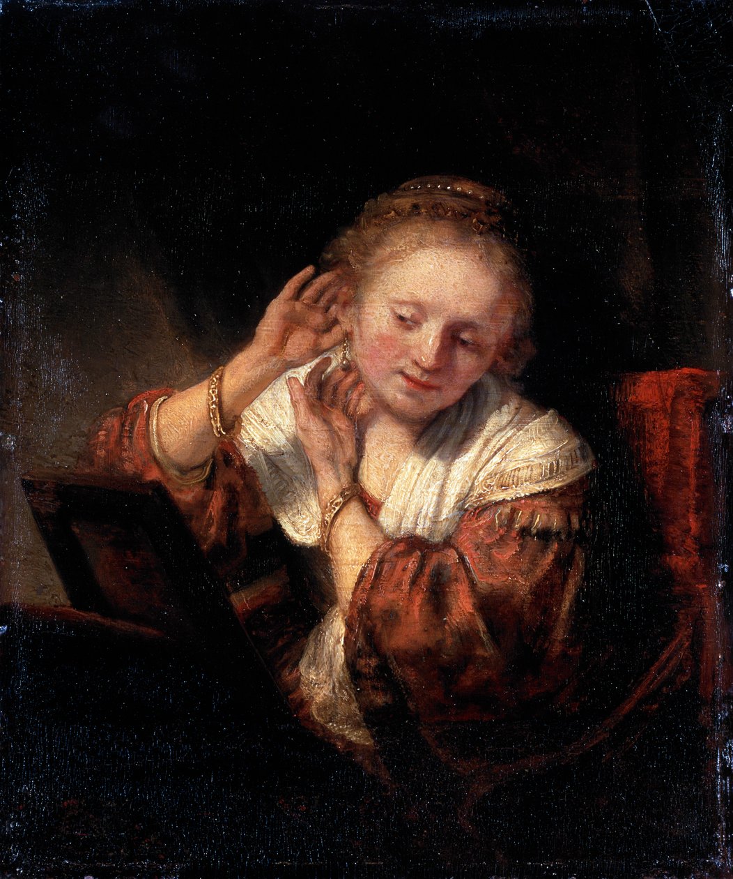 Junge Frau probiert Ohrringe an, 1657 von Rembrandt van Rijn
