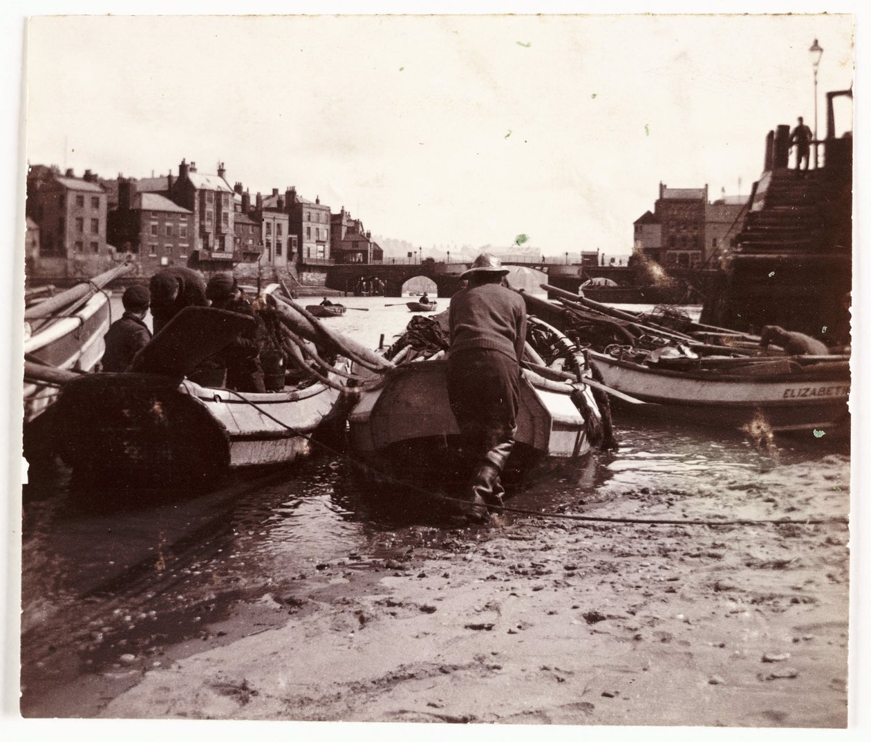 Mann lässt ein Fischerboot zu Wasser, Whitby Hafen, um 1901 von Unbekannt