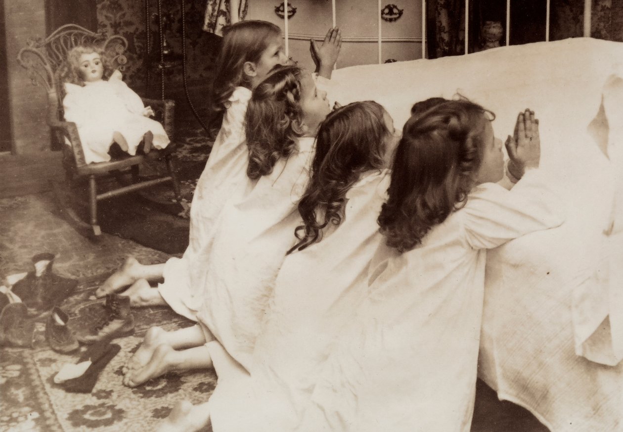 Vier kleine Mädchen knien am Bett und sprechen ihr Abendgebet von Unknown photographer
