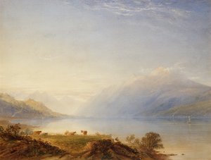 Rinder an einem See mit Bergen im Hintergrund