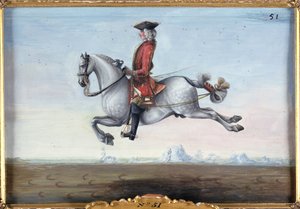 Ein Apfelschimmel der Spanischen Hofreitschule bei einer Dressurbewegung namens Capriole von Baron Reis Eisenberg