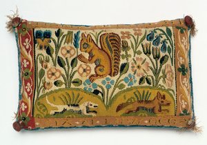 Ein Nadelkissen-Wandteppich mit einem Eichhörnchen und dem Motto 
