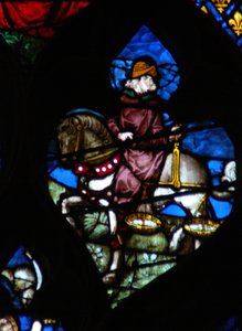 Das westliche Rosenfenster zeigt eine Szene aus dem Buch der Offenbarung: Ein Reiter (sein Pferd nicht schwarz wie im Text) trägt die Waage, um Weizen und Gerste zu messen (6:5). von French School