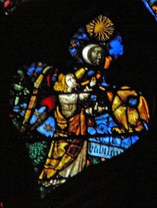 Das westliche Rosenfenster zeigt eine Szene aus dem Buch der Offenbarung: vierte Trompete Sonne, Mond und Sterne verdunkeln sich, und der Adler als Engel schreit Wehe, Wehe, darunter geschrieben (8:12-13).