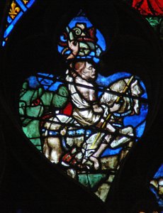 Das westliche Rosenfenster zeigt eine Szene aus dem Buch der Offenbarung: bleiches Pferd mit der grotesken Figur des Todes, bewaffnet mit einem Speer und Vipern. Er taucht aus dem riesigen grünen Maul der Hölle auf.