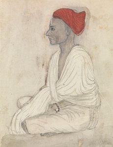 Mann mit rotem Turban im Schneidersitz