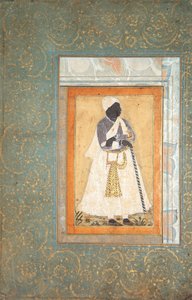 Ein schwarzer Mann lehnt an einem langen Stab von Indian School