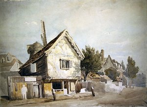 Eine Straße mit alten Häusern, eine Windmühle dahinter