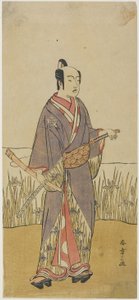 (Ein Schauspieler in einer Samurai-Rolle mit einer Bambusflöte)