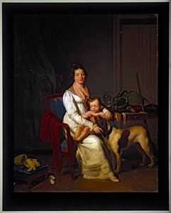 Eine junge Dame mit einem Kind und einem Hund in einem Innenraum