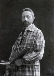 Dreiviertelporträt des Malers Guido Spadolini. Er trägt einen langen Kittel und hält Pinsel und Palette in der linken Hand, 26.11.1901