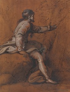 Mann sitzt auf einem Felsen
