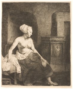 Frau sitzt halb angezogen neben einem Ofen von Rembrandt van Rijn