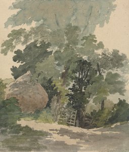Ein Feldweg mit Heuhaufen und Tor