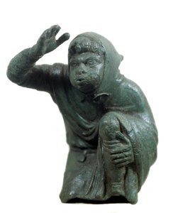 Römische Kunst: bronzene Statuette eines knienden schwarzen Sklaven, der bläst