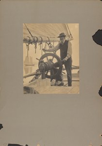 Mann am Steuerrad eines Schiffes