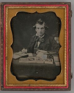 Unbetiteltes Porträt eines sitzenden Mannes, der ein Daguerreotyp und einen Pinsel hält, 1865 von Samuel J. Miller