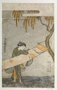 Junge Frau, die ein Kakemono an einen Baum bindet