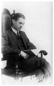 Mann sitzt auf einem Stuhl und liest ein Buch, 1918 von Unbekannt