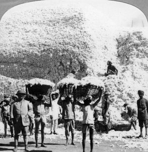 Männer tragen Baumwollkörbe in einer Baumwollspinnerei in Indore, Indien, 1900er