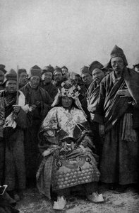 Tibet. Magier in voller Montur und eine bewundernde Gruppe von Mönchen. 1920 von Unbekannt
