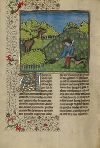 Ein Jäger und ein Hund untersuchen die Spur eines Hirsches