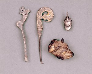 Verschiedene Stücke von Apparaten und Wikingerjuwelen, oben rechts eine Darstellung der Gottheit Odin. Stockholm, Historiska Museet