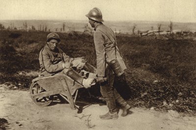 Gefangener französischer Soldat transportiert seinen verwundeten Kameraden in einer Schubkarre, Erster Weltkrieg von Photographer German