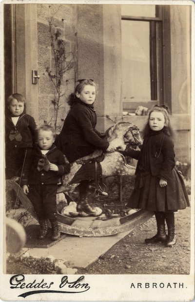 Gruppe von kleinen Kindern und ihr Schaukelpferd von Scottish Photographer