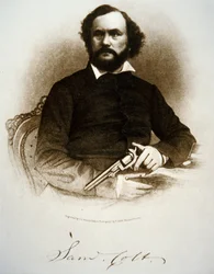 Samuel Colt hält einen seiner Perkussionsrevolver