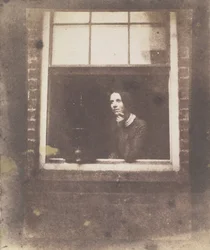 Dame am offenen Fenster mit Vogelkäfig, späte 1840er