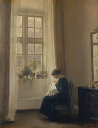 Ein Mädchen näht in einem Innenraum