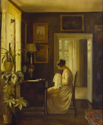 Ein Interieur mit einer Frau, die näht