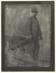 Schwarzer Mann mit Schubkarre