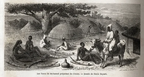 Vorbereitung von Elfenbein, für einen türkischen Händler, Uganda, Zeichnung von Emile Bayard (1837-1891), zur Illustration von Captain Spekes Entdeckungsreise in Afrika von 1860 bis 1863. Gravur in Le Tour du Monde, herausgegeben von Edouard Charton