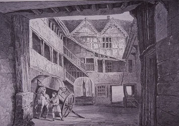 Stallknecht kümmert sich um Pferd im Hof des New Inn, Gloucester