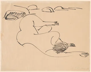 Erna liegt am Strand zwischen Felsen