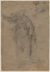 Schwer drapierte, stehende Frau nach rechts gedreht und nach unten blickend mit ausgestrecktem rechten Arm und einer Skizze für einen Kopf