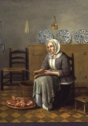 Eine sitzende Frau, die Essen in einer Küche zubereitet