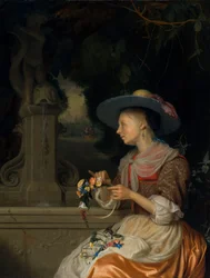 Frau, die einen Blumenkranz flicht