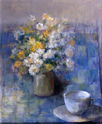 Teetasse und Gänseblümchen