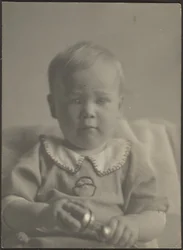 [Baby mit silberner Rassel]