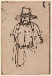 Stehender Mann mit breitkrempigem Hut