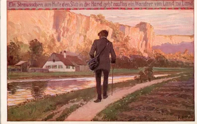 Ein Sträußchen am Hut, den Stab in der Hand