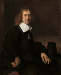 Ein junger Mann sitzt an einem Tisch, möglicherweise Govaert Flinck
