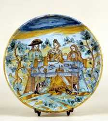 Darstellung eines Banketts im Freien auf einem Keramikteller von Talavera de la Reina (Spanien). Frühes 16. Jahrhundert. Mailand, Museo del Castello.