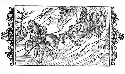 Pferd zieht auf dem Schnee eine Bärenhaut, auf der ein Finne sitzt - in 