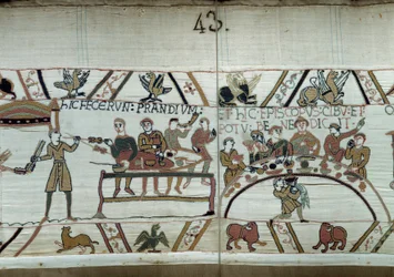 Landung in England, die Truppen von Wilhelm dem Eroberer feiern, während sie auf den Kampf gegen die sächsischen Waffen von Harold II. warten. Guillaume ist umgeben von Baronen und dem Bischof Odon. Detail des Teppichs von Bayeux